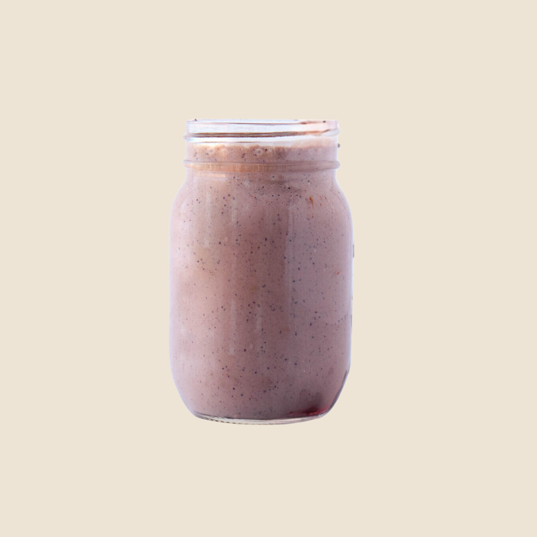 Nutrient-dense wholefood protein shake in a mason jar with a straw, packed with healthy ingredients