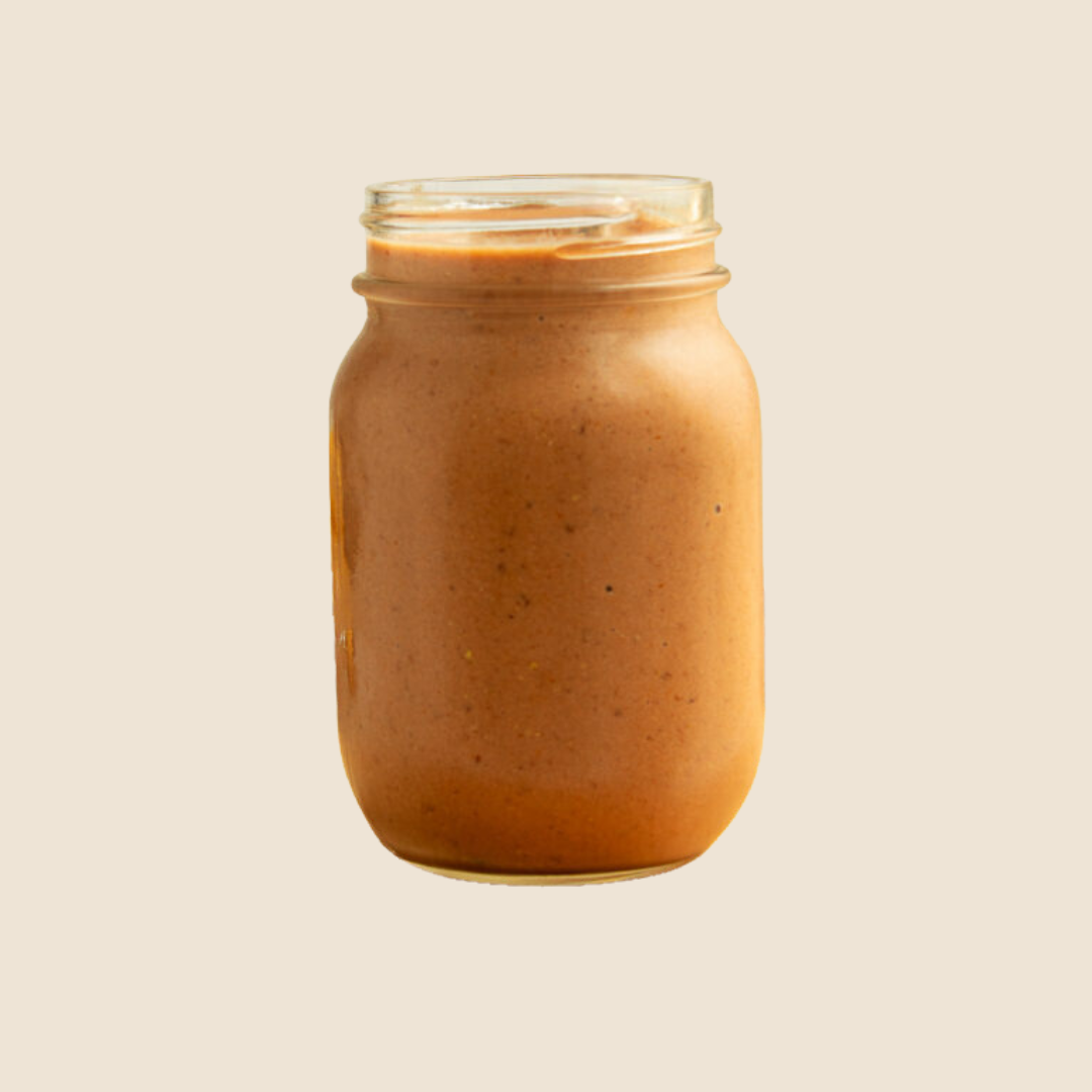 Nutrient-dense wholefood protein shake in a mason jar with a straw, packed with healthy ingredients