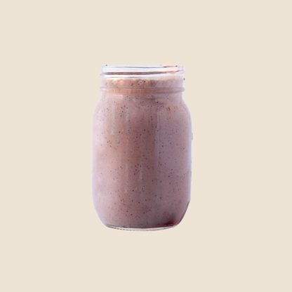 Nutrient-dense wholefood protein shake in a mason jar with a straw, packed with healthy ingredients